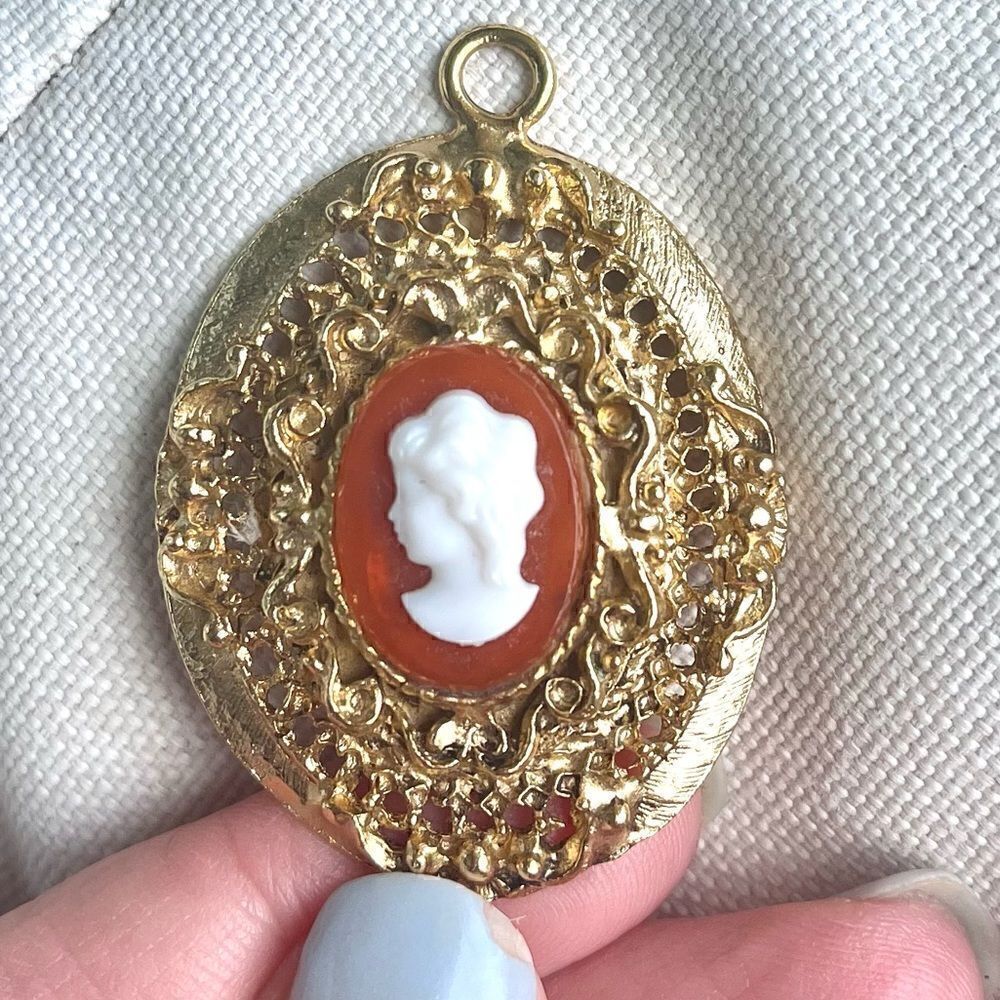 Vintage Classic Oval Cameo Pendant Surrounded by Gold Tone Filagree Work.
